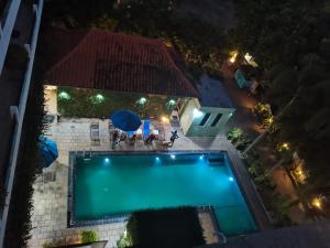 an overhead view of a swimming pool at night at Ceylan Lodge Anuradhapura in Anuradhapura