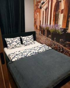 a bed with two pillows on it in a room at Rynek aparts in Wrocław