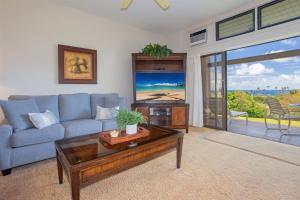 a living room with a couch and a coffee table at 412 Ridge in Kahana