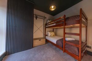 a bedroom with two bunk beds and a closet at Cottage style with lovely mountain views in Moffat