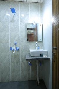 a bathroom with a sink and a mirror at Hotel Basil Inn in Agra +32 photos