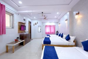 a hotel room with two beds and a desk at Basil Inn Homestay - Walk-In Distance to Taj Mahal in Agra