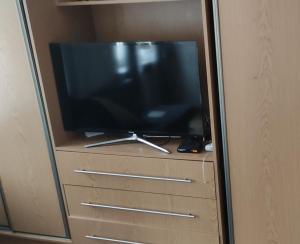 a flat screen tv sitting on top of a dresser at Rynek aparts in Wrocław