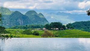 a large body of water with mountains in the background at PuLuong Bản in Lũng Tiềm +37 photos