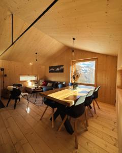 a living room with a table and a couch at ALTYPIC Mayen d'exception en Valais in Bruson
