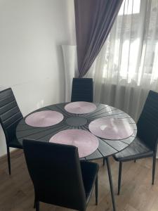 a dining room with a table and four chairs at Casa Elena, Ocna Mureș in Ocna-Mureşului