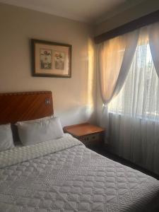 a bedroom with a bed and a window at Nathi Lodge in New Germany