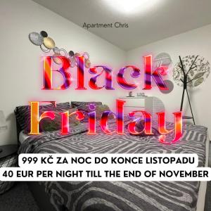 a bedroom with a sign that reads black indiah at CHRIS Apartment in Dalovice