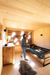 a person walking through a room with a bed at ALTYPIC Mayen d'exception en Valais in Bruson