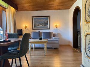 a living room with a couch and a table at Altenburger Hof in Reit im Winkl