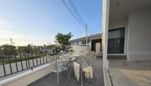 a patio with a table and chairs on a balcony at 18TU Thammasat in Pathum Thani