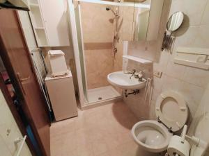 a small bathroom with a toilet and a sink at Casina Giulia in Capistrello
