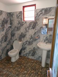 a bathroom with a toilet and a sink at Mountain Breeze Inn Midigama in Midigama +38 photos