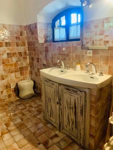 a bathroom with a sink and a mirror at Le Mas du Pourret in Pierrefeu-du-Var