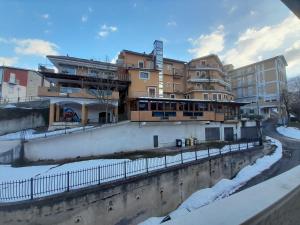 a building in a city with snow on the ground at Appartamento Elena in Caramanico Terme +1 photo