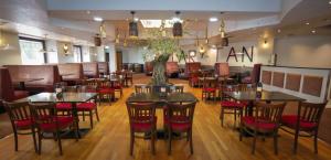 a restaurant with tables and chairs in a room at Lovat Hotel in Perth +136 photos