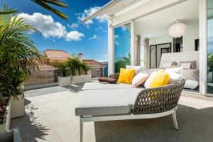 a living room with a couch on a patio at New Villa Los Olivos in Adeje
