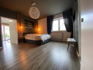 a bedroom with a bed and a window and a chandelier at Atelier 1a in Cottbus