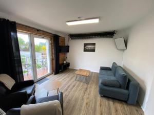 a living room with a couch and a table at Atelier 1a in Cottbus