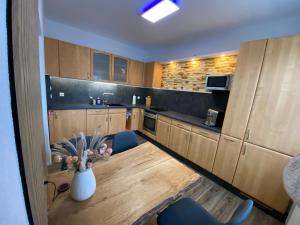 a kitchen with a table and a vase of flowers at Atelier 1a in Cottbus