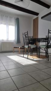 a room with chairs and a table and a window at Stéphanie in Remoulins