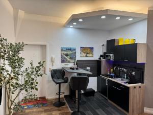 a kitchen with a counter and a table and chairs at Apartment Van Gogh in Osterburg Siedlung