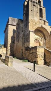 an old building with a tower and an archway at Stéphanie in Remoulins