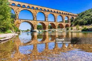 a bridge over a river with reflections in the water at Stéphanie in Remoulins
