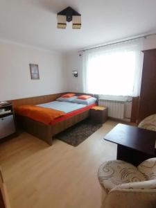 a bedroom with a bed and a window and a table at Willa Górniak in Dziwnówek +42 photos