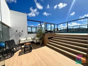 a balcony with a couch and stairs on a building at Studio H Residencial Flipchave STH000 in Boa Vista