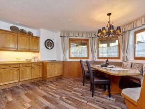 a kitchen with a table and chairs and a dining room at Apart Helga in Oberlängenfeld +7 photos