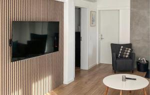 a living room with a television on a wall at Stunning Home In Sydals With Sauna in Skovbyballe
