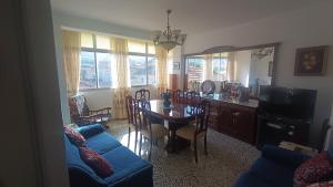 a living room with a table and a dining room at Lorca in Dúrcal