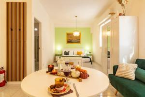 a living room with a white table and a bed at Casa Violante in Ancona