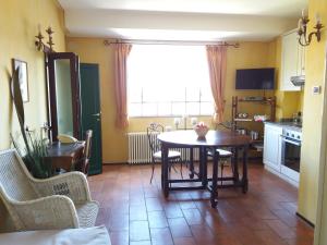 a kitchen with a table and chairs and a dining room at Garden Apartment in Lesa