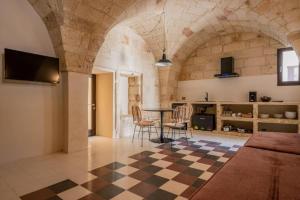 a living room with a checkered floor and a table at Le Casine di Maruggio Albergo Diffuso in Maruggio