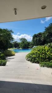 a view of a beach with the ocean in the background at TDJ Japandi Room with Residential Pool access in Tambuli Seaside Mactan in Maribago
