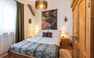 a bedroom with a bed and a painting on the wall at Das Halali - dein kleines Hotel an der Zugspitze in Ehrwald