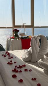 a pile of red rose petals on a bed at SEAVIEW HOTEL in Umm Lujj