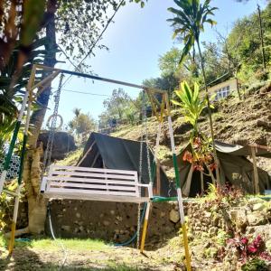 a bench in front of a house at Green River Camp in Rishīkesh