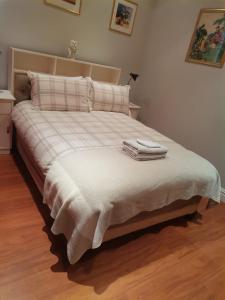 a bedroom with a bed with two towels on it at Dalebrook Sea-Facing Apartment in Kalk Bay in St James