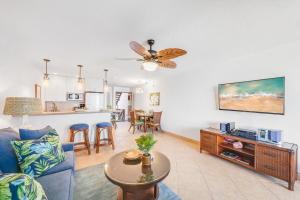 a living room with a couch and a table at Kulakane 211 · KK 211 Updated OceanFront Whale Watching in Kahana
