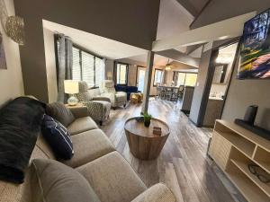 a living room with a couch and a tv at Lakefront Home-3bd25badockgrillfirepitpool in Arrowhead Beach