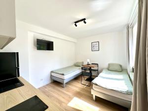 a room with two beds and a television in it at leszczynki parter III in Gdynia
