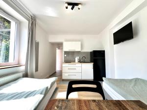 a small room with two beds and a kitchen at leszczynki parter III in Gdynia