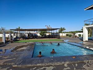 a group of people swimming in a swimming pool at The Private Location in Thohoyandou +35 photos