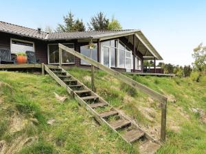 een huis met een houten trap ervoor bij 6 person holiday home in Højslev-By Traum in Bøstrup