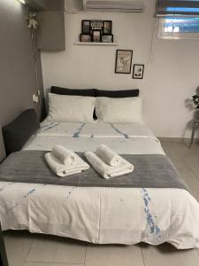 a bedroom with a bed with two towels on it at MY HOME Trikala in Tríkala