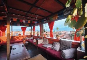 a bar with red couches and a view of a city at Swastik Guest House in Bhaktapur