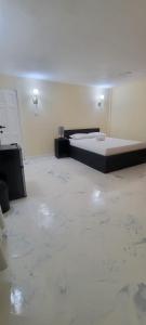 a room with a bed in a room with marble floors at Lovely 2 bedroom in the city in Saint Georgeʼs +9 photos
